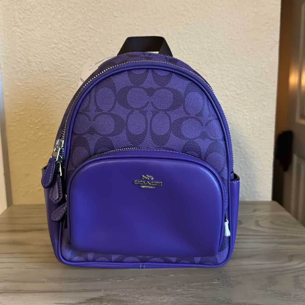 court mini backpack Coach Refined pebble leather Inside zip and multifunction pockets Double zip closure fabric lining Handle with 1 1/2 drop Outside zip and open pockets Adjustable shoulder straps 8 (L) x 9 (H) x 3 1/2 (W) The Coach Foundation continues to partner with the Hetrick Coach Mini Court Strawberry Backpack